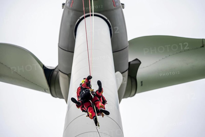 Height rescuers from the Gelsenkirchen fire brigade practise abseiling from a wind turbine from a height of 110 metres after rescuing an accident victim from the nacelle, Gladbeck, North Rhine-Westphalia, Germany, Europe