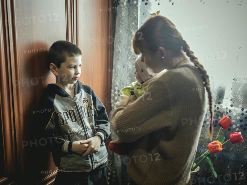 Nasar with his cousin Bogdana and baby Polia in their family home in Voloska Balakliia. The village is close to the front line, artillery fire can be heard every day, Voloska Balakliia, Kharkiv Oblast, Ukraine, Europe