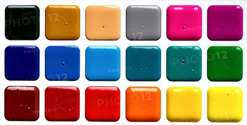 Watercolor paints in a plastic box, on a white background, top view, close-up, no people
