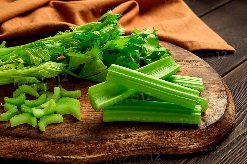 Fresh bunch of celery, top view, no people, on a dark background