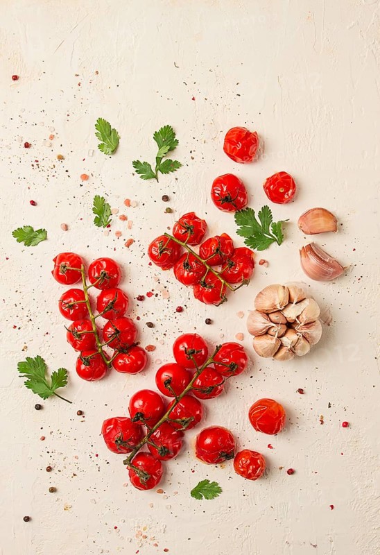 Baked branch, mini, cherry tomatoes, with spices and herbs, garlic, food background, top view, on a white background
