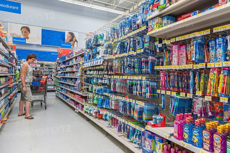 Woman shopping on oral hygiene isle at Walmart shopping center in Biloxi, Mississippi, USA, North America