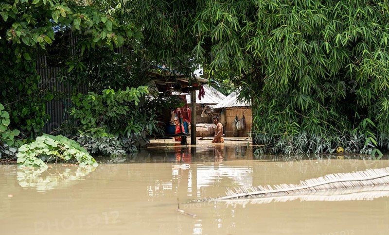 Morigaon, India. 4 July 2024. Residents in their flooded house, in a flood affected village in Morigaon district in India's northeastern state of Assam on July 4, 2024. Torrential rains and surging rivers across northeast India have killed at least nine people, with more than 1.5 million people affected