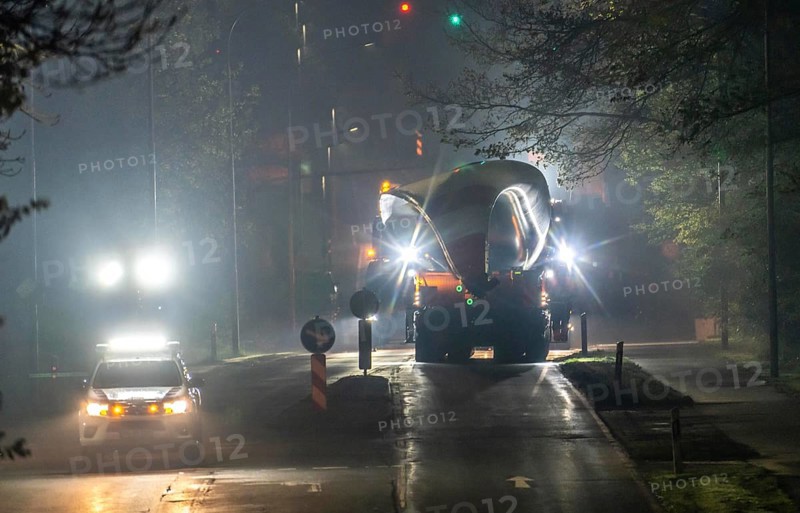 Transport of a 68 metre long, 22 tonne blade of a wind turbine, here in Breckerfeld, with a self-propelled Blade-Lifter vehicle, over a 40 km long route, over 2 nights, in the Bergisches Land, through towns, villages, over country roads, narrow through roads, to the construction site of the wind turbine near Hagen, North Rhine-Westphalia, Germany, Europe