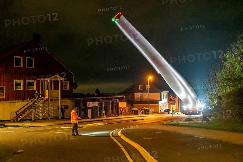 Transport of a 68 metre long, 22 tonne blade of a wind turbine, here in Schwelm, with a self-propelled Blade-Lifter vehicle, over a 40 km long route, over 2 nights, in the Bergisches Land, through towns, villages, over country roads, narrow through roads, to the construction site of the wind turbine near Hagen, North Rhine-Westphalia, Germany, Europe