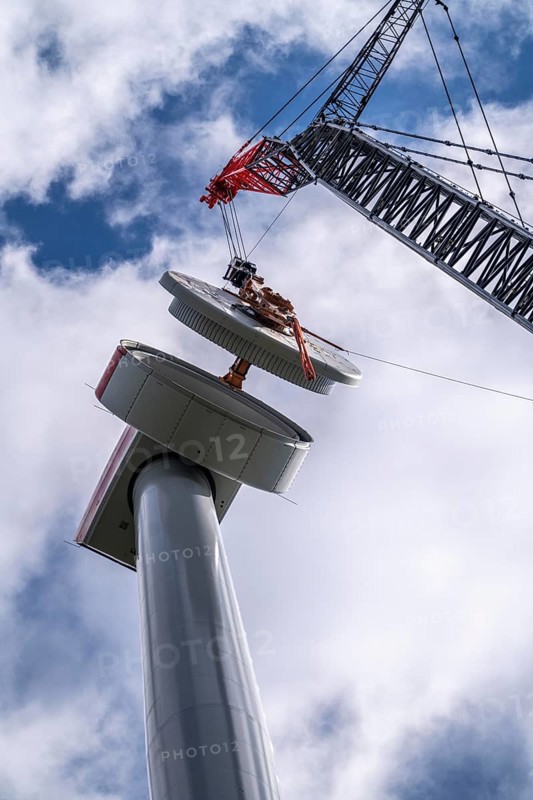 Erection of a wind turbine, wind energy plant, assembly of the ring generator, with a crawler lattice crane, wind farm near Hagen, North Rhine-Westphalia, Germany, Europe