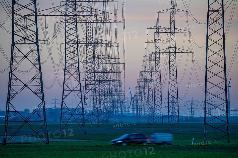 Extra-high-voltage lines, 380 KV, power line, wind turbine, the electricity comes from the Rhenish lignite mining area, at the Neurath power station, near Grevenbroich, Germany, Europe