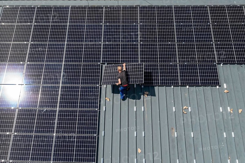 Installation of solar modules on the roof of a barn on a farm, over 210 photovoltaic modules are installed on the roof, North Rhine-Westphalia, Germany, Europe