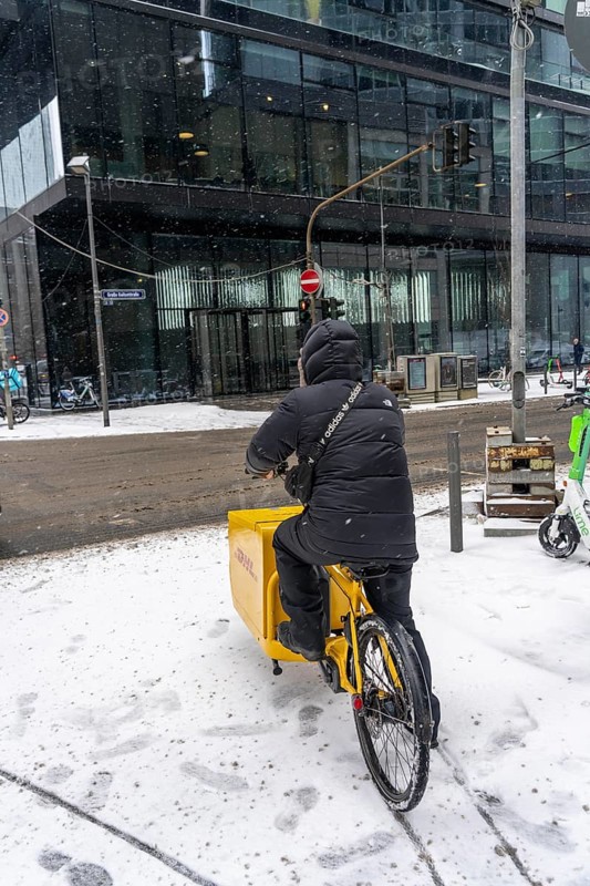 Winter in Frankfurt, DHL bicycle courier in the banking district, Hesse, Germany, Europe