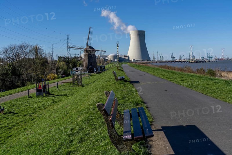 The Doel nuclear power plant on the Scheldt, one of two nuclear power plants in Belgium, consists of three operating units, each with a pressurised water reactor, as well as a decommissioned unit, historic Scheldemolen, windmill on the Scheldt dike, Antwerp, Belgium, Europe