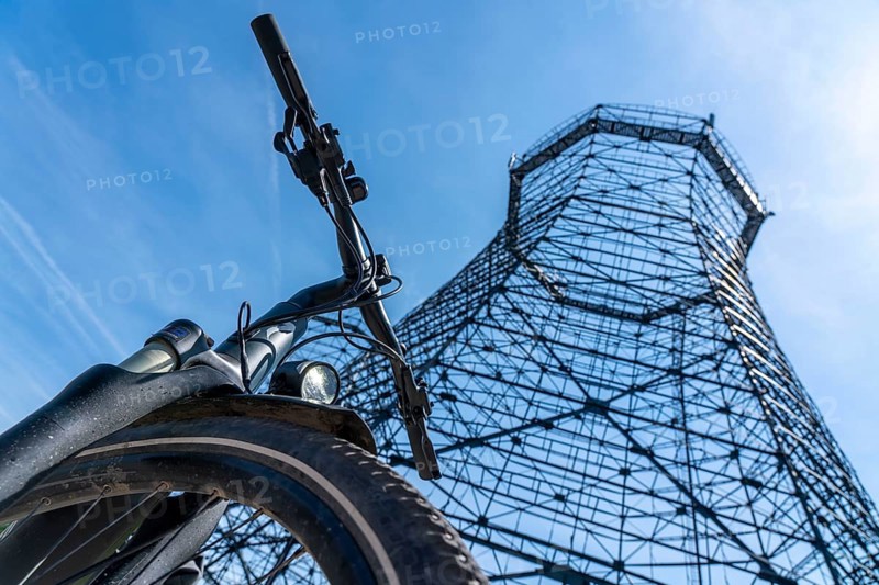 Cycling in the Ruhr area, at the Zollverein Coal Mine Industrial Complex World Heritage Site, lattice cooling towers on the coking plant site, Essen, North Rhine-Westphalia, Germany, Europe