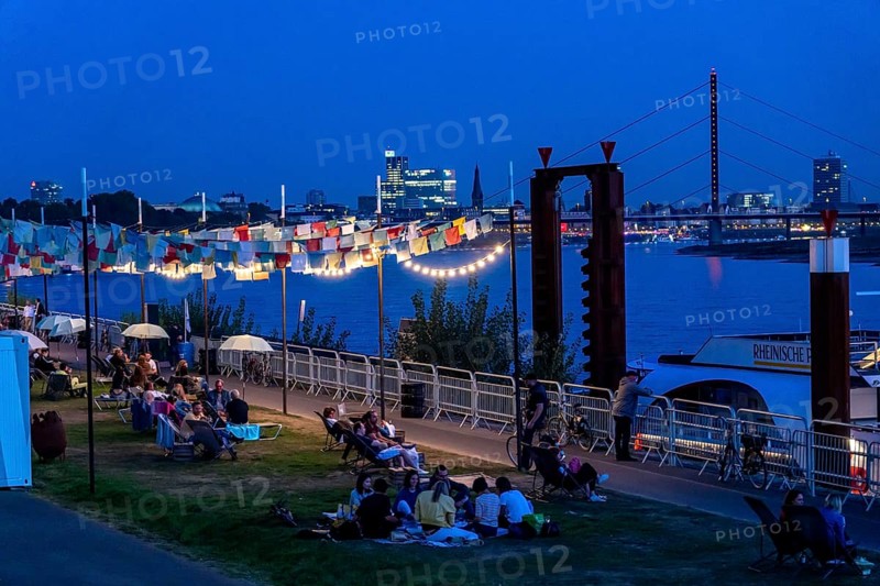 Skyline of Düsseldorf on the Rhine, sunset, city beach at the Theodor-Heuss-Bridge, temporary catering directly on the Rhine, Düsseldorf, North Rhine-Westphalia, Germany, Europe
