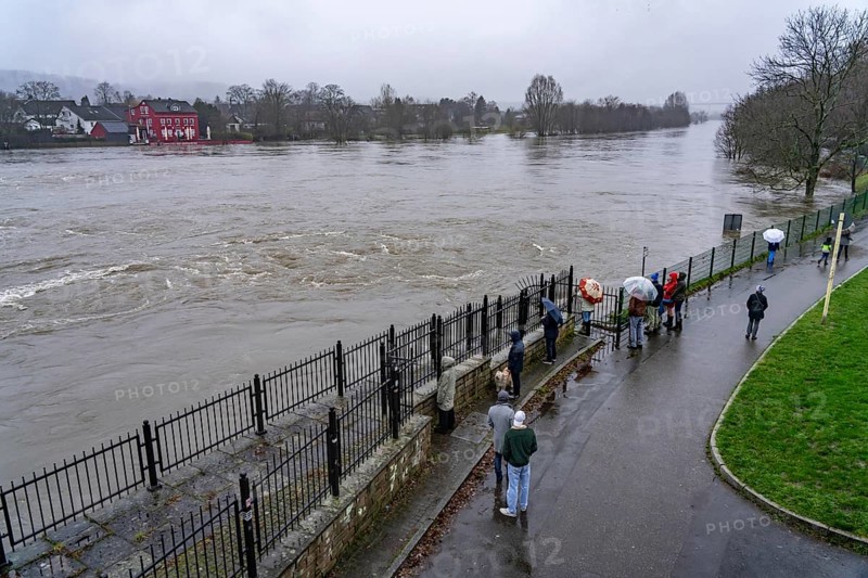 Spectators at high water on the Ruhr, here near Essen-Kettwig, below the weir of the Ruhr reservoir after days of continuous rain, North Rhine-Westphalia, Germany, Europe