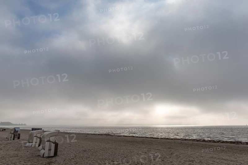 Rain clouds over the Flensburg Fjord, empty beach at Drei, beach chairs, Holnis peninsula, sunlight breaking through, Glücksburg, Schleswig-Holstein, Germany, Europe