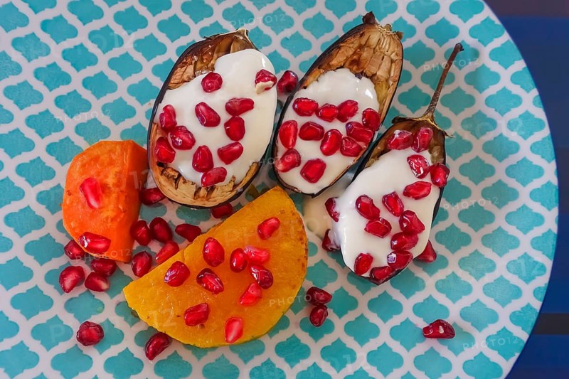 Mediterranean cuisine, roasted aubergines with pomegranate seeds and yoghurt, sweet potatoes, starter, healthy, vegetables, vegetarian, food photography, studio, Germany, Europe