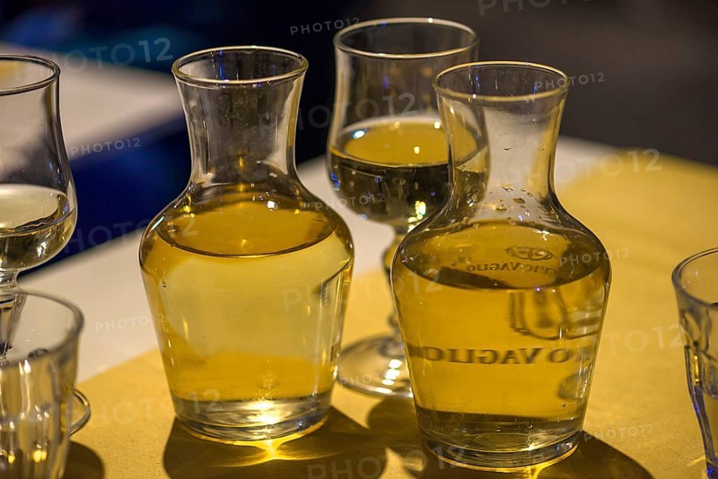 White wine in two small carafes and a glass on the table of a restaurant, Genoa, Italy, Europe