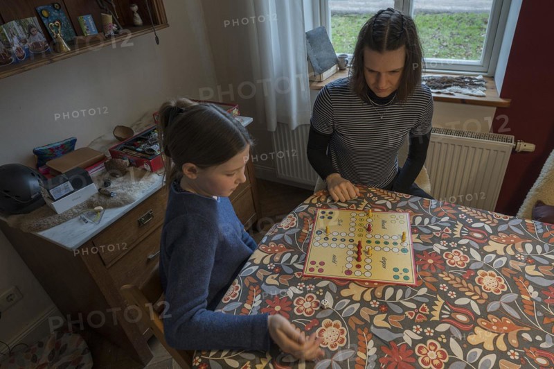 Two sisters playing the parlour game Mensch Ärgere Dich nicht, Mecklenburg-Vorpommern, Germany, Europe