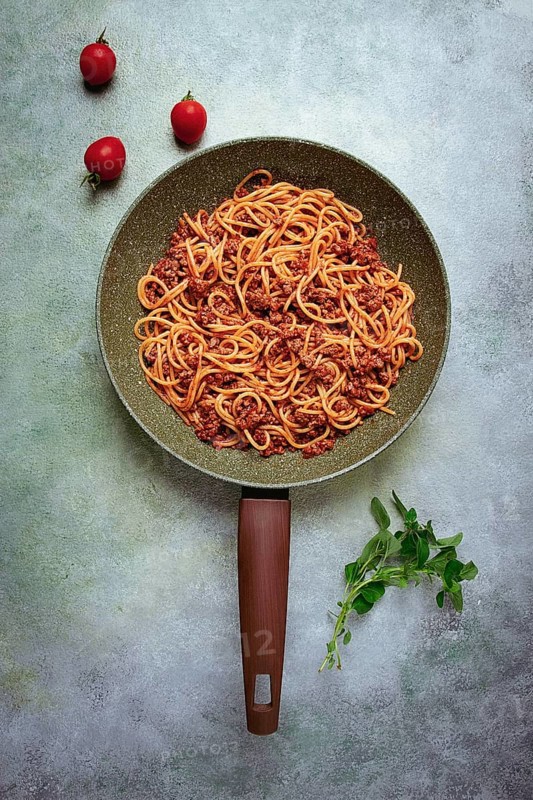 Spaghetti bolognese, in a frying pan, top view, homemade, no people