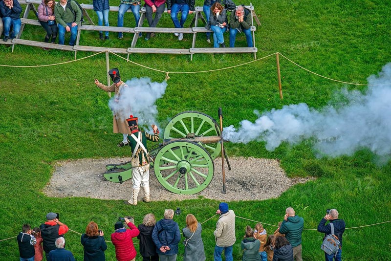 Tourists watching Napoleonic war reenactors firing cannon at the Domain of the Waterloo 1815 Battlefield at Braine-l'Alleud, Wallonia, Belgium, Europe