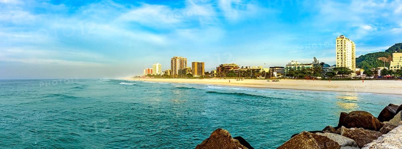 Panoramic photograph of Barra da Tijuca beach seen from the breakwater pier at dawn in the city of Rio de Janeiro Rio de Janeiro, RJ, Brazil, South America