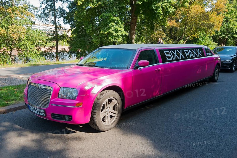 An eye-catching pink limousine parked on the roadside under trees in daylight, stretch limousine, Chrysler, Berlin, Germany, Europe