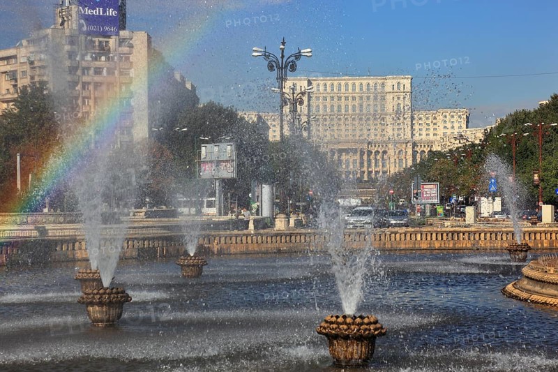 City centre, fountains and skyscrapers at Bulevardul Unirii, behind the Palace of Parliament, Bucharest, Romania, Europe