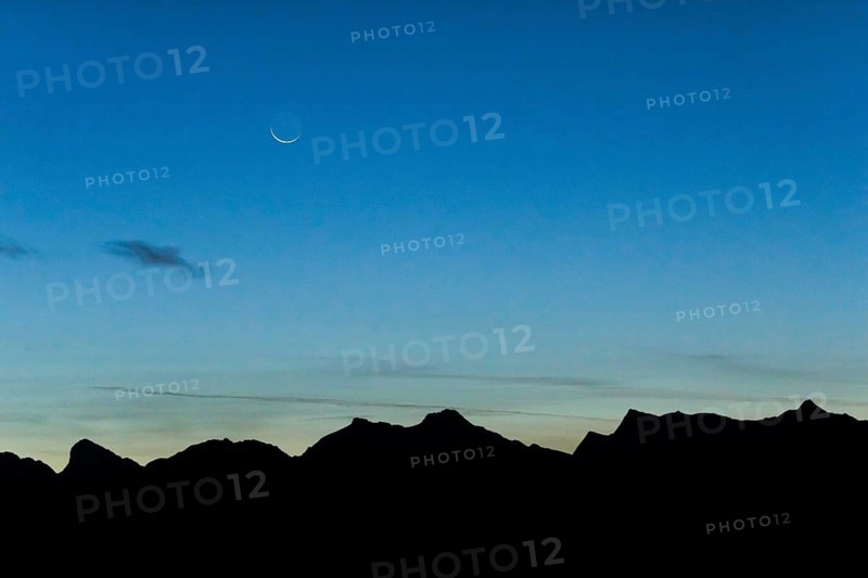 Crescent moon over mountain silhouette, Valais, Swiss Alps