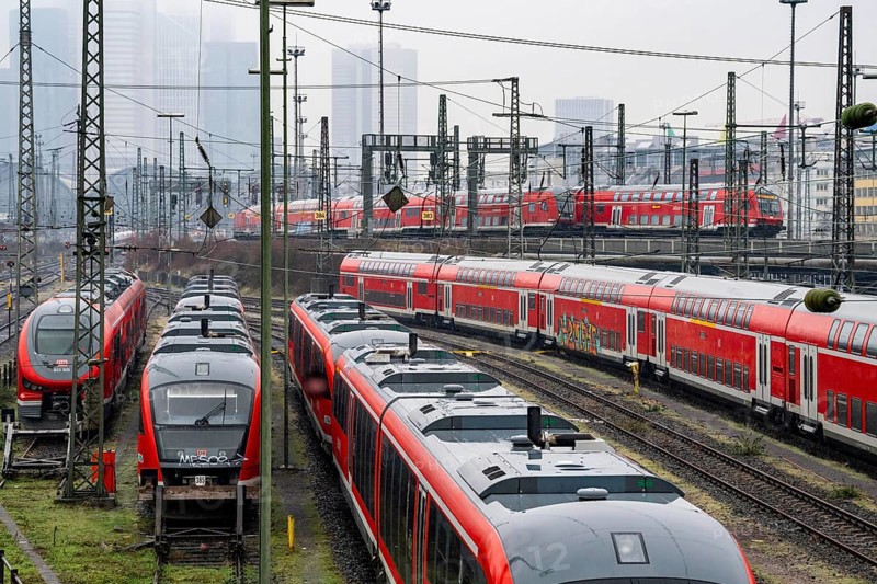 Railway tracks with regional trains, after freezing rain, in front of Frankfurt main station, skyline in the fog, Hesse, Germany, Europe