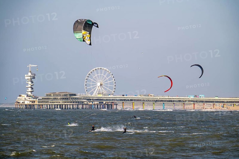 The pier and Ferris wheel at Scheveningen beach, strong swell, windsurfers, kitesurfers, Netherlands