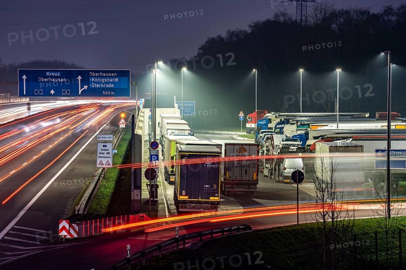 Heavy traffic on the A2 at the Schwarze Heide rest area, Bottrop, overcrowded car park for trucks in the evening, Bottrop, North Rhine-Westphalia, Germany, Europe