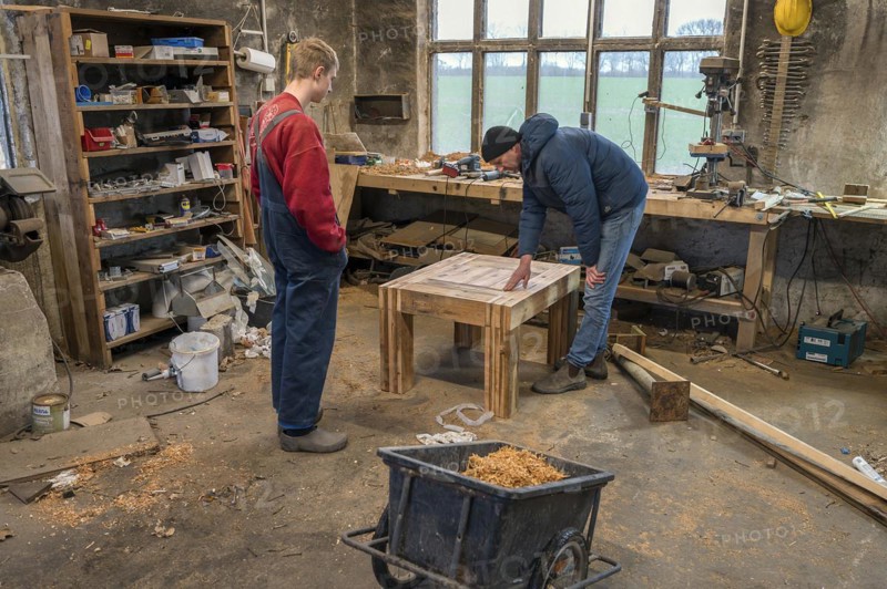 Father and son looking at the table built by the son in the workshop, Mecklenburg-Vorpommern, Germany, Europe