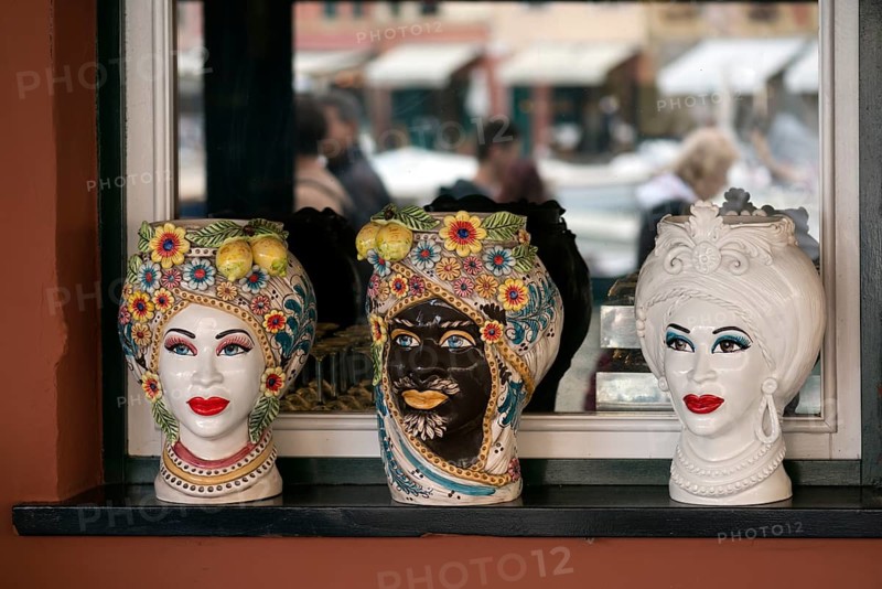 Decorative vases designed with Indian faces, in the window of an Indian restaurant, Portofino, Italy, Europe
