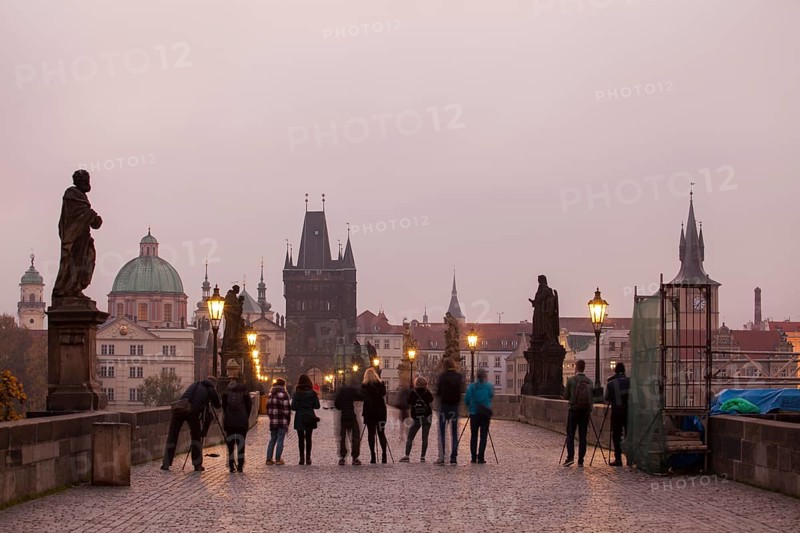 Photographers with tripod and camera on the Charles Bridge in Prague