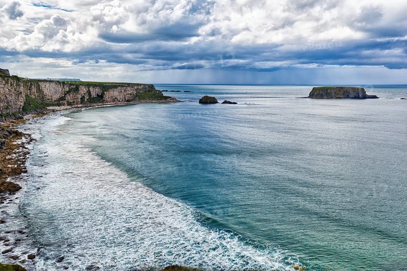View of the sea, cliff coast, chalk cliffs, dramatic cloudy sky, rain clouds, Causeway Coastal Route, Antrim, Northern Ireland, Great Britain