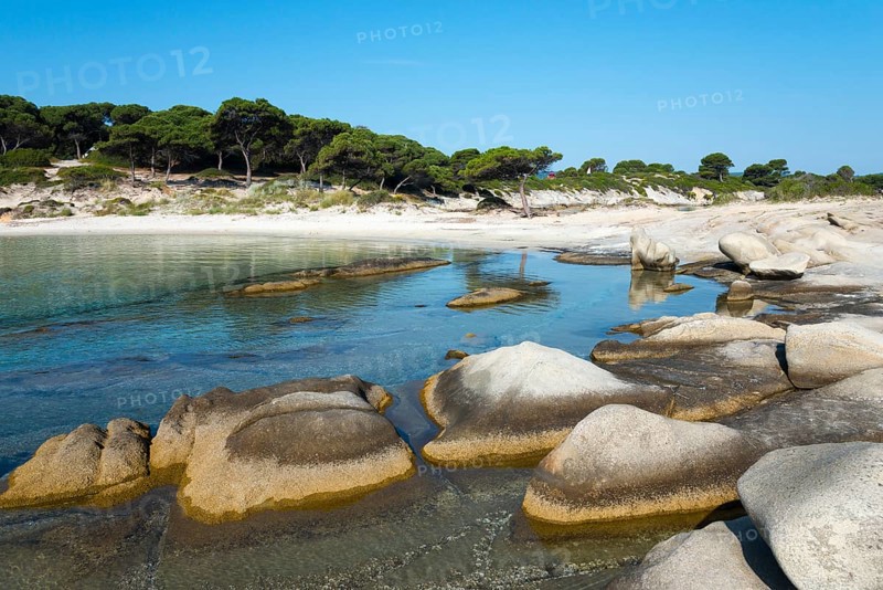 Tranquil coastal view with rocks and a sandy shore under a clear sky, Karidi beach, Karydi, Vourvourou, Sithonia, Halkidiki, Central Macedonia, Greece, Europe
