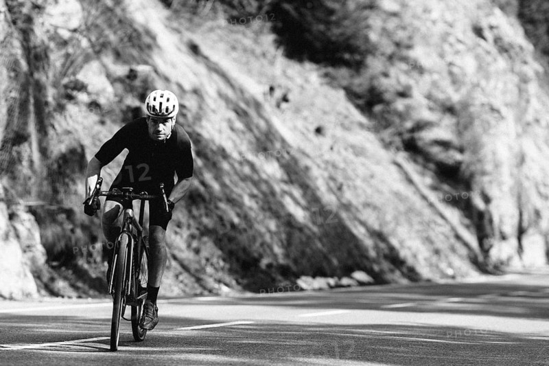 Road bike rider in spring between Lechtal and Tannheimer Tal in front of picturesque scenery of the Alps, Tyrol, Austria, Europe