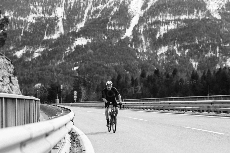 Road bike rider in spring between Lechtal and Tannheimer Tal in front of picturesque scenery of the Alps, Tyrol, Austria, Europe