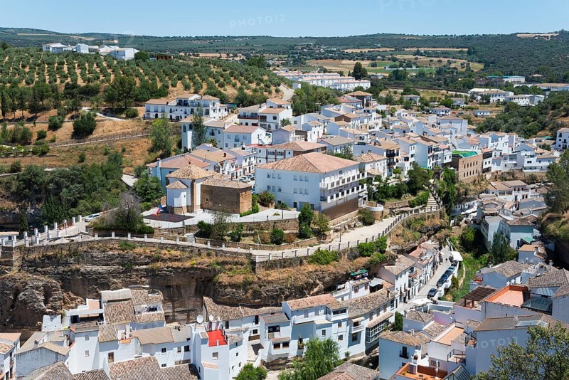 Panoramic view over a village with olive groves and white buildings on hillsides, cave dwellings, Setenil de las Bodegas, Cadiz, Andalusia, Spain, Europe