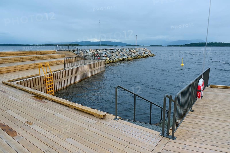 Outdoor sea pool by the fjord, overcast sky and calm water, Molde, Romsdal, Norway, Europe