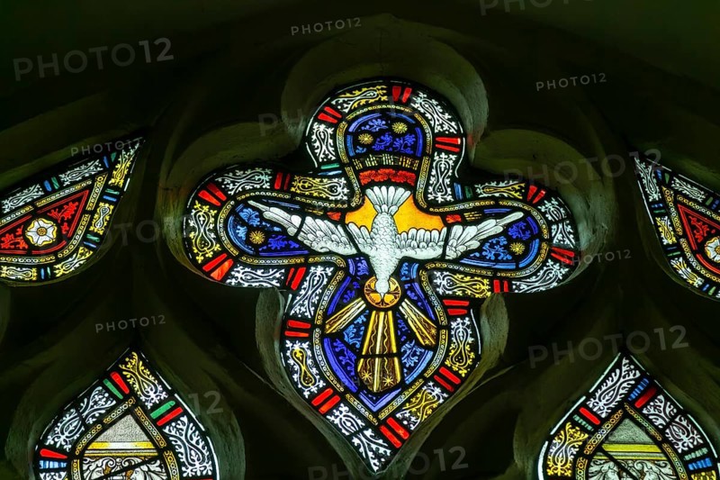 Detail of stained glass window by Charles Eamer Kempe, church of Saint Botolph, Burgh, Suffolk, England, UK c 1902 Holy Ghost dove