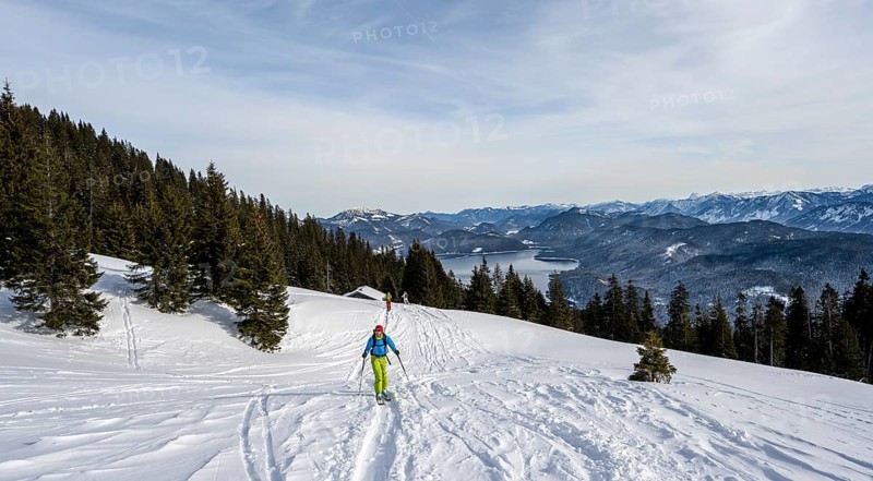 Ski tourers climbing Simetsberg, view of Walchensee, Estergebirge, Bavarian Prealps, Bavaria Germany