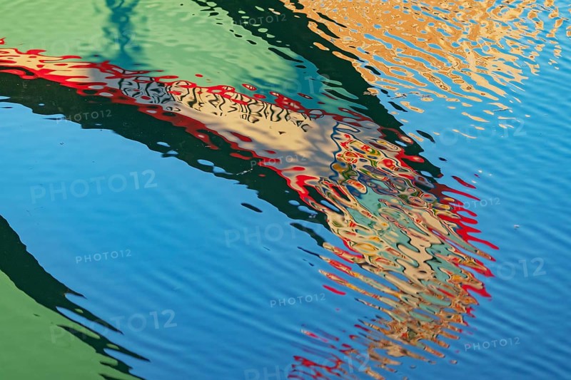 Traditional Moliceiro boat reflected in the water, Aveiro, Portugal, Europe