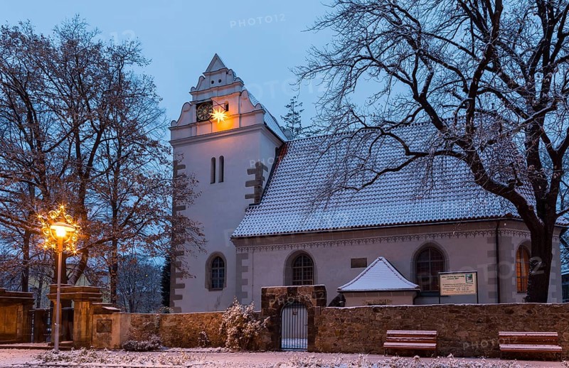 Old church with illuminated poinsettia, snowy and at dusk, Coswig, Saxony, Germany, Europe