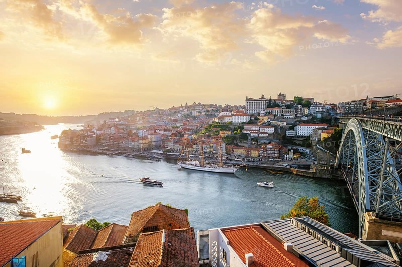 View of Porto city and Douro river and Dom Luis bridge I from famous tourist viewpoint Miradouro do Jardim do Morro on sunset. Porto, Vila Nova de Gaia, Portugal, Europe