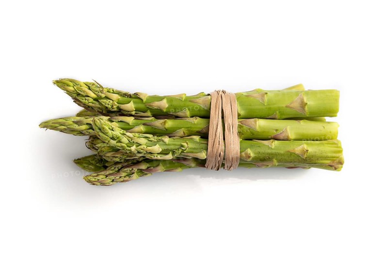 Bunch of fresh green asparagus isolated on white background. Top view, flat lay, close up. harvest, healthy, vegan food, concept, minimalism