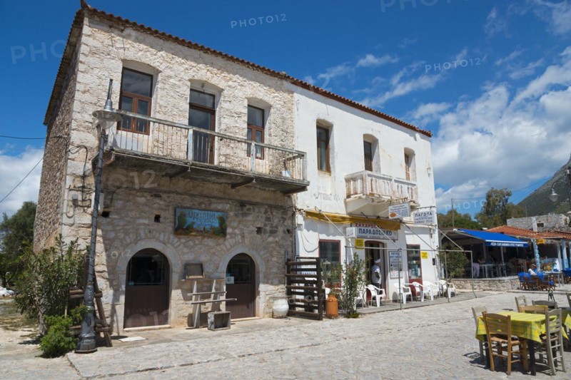 Stone building with restaurant terrace under a clear blue sky and a mountain in the background, Old Town, Areopoli, Areopolis, Tsimova, Itylo, Anatoliki Mani, Mani, Laconia, Peloponnese, Greece, Europe