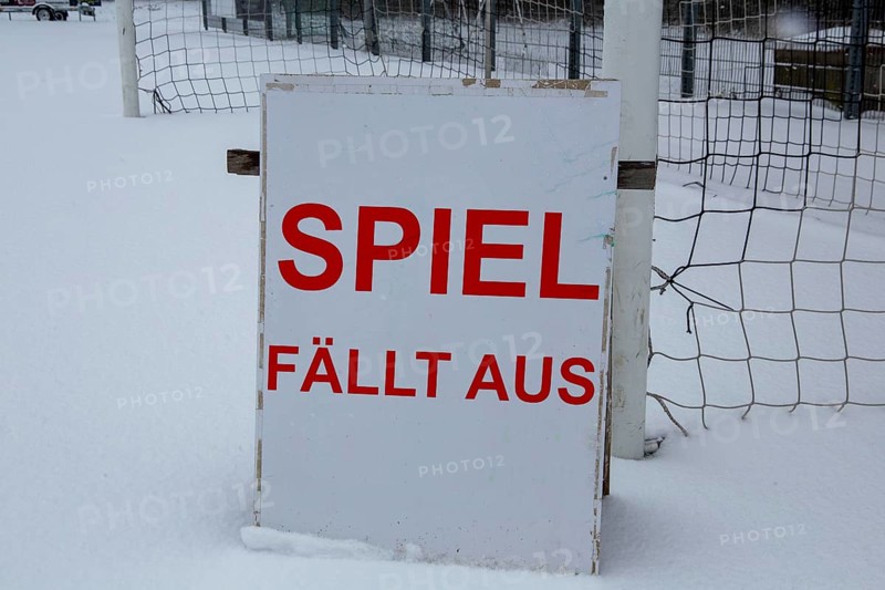Symbolic image of a football match cancelled due to snow. Sign on a sports field with the inscription GAME CANCELLED