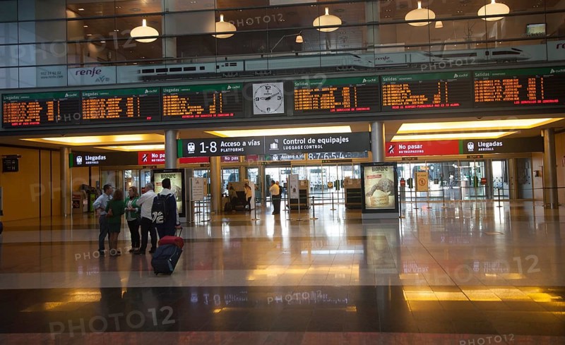 Passengers looking at display board information inside, Maria Zambrano railway station, Malaga, Spain, Europe