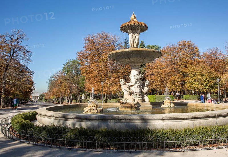 People walking by monument fountain in El Retiro park, Madrid, Spain, Europe