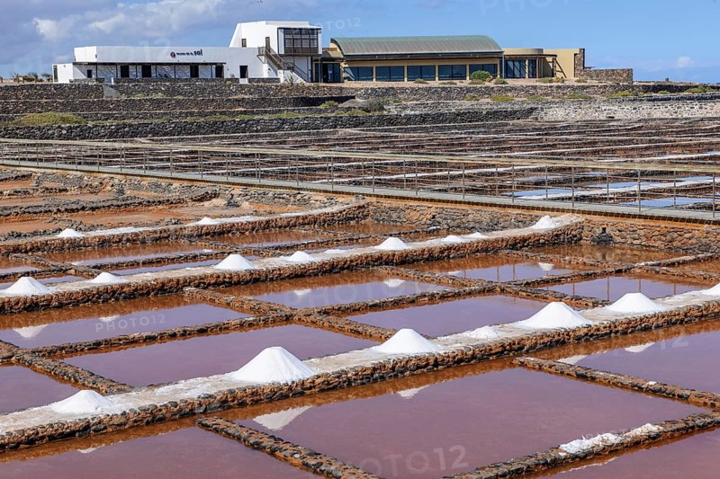 Historic salt works for salt extraction, now the salt museum Museo de la Sal, in the foreground small reservoirs for the evaporation of salt water, next to it skimmed sea salt, Antigua, Fuerteventura, Canary Islands, Spain, Europe